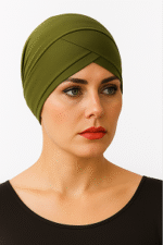 A person wearing an olive-green headscarf and a black top, showcasing a stylish and modest look against a white background.